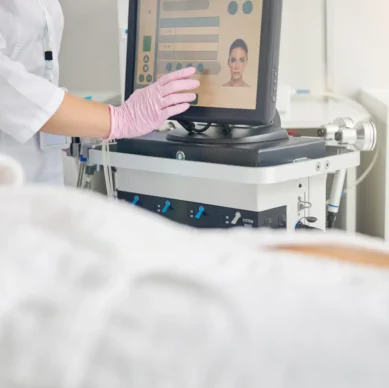 Cropped photo of a dermatologist adjusting the treatment parameters for her client before the dermabrasion procedure