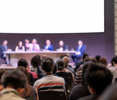 Rear view of Audience in the conference hall or seminar meeting Rear view of Audience in the conference hall or seminar meeting which have Speakers are Brainstorming and talking on the stage, business and education about investment concept